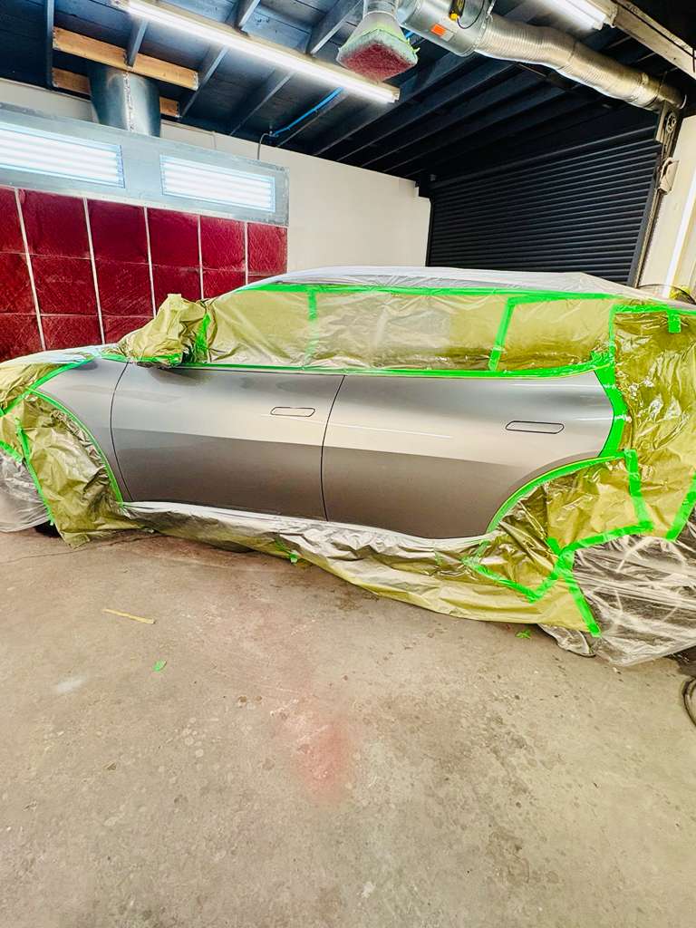 Vehicle prepped inside the spray booth ready for factory-matched paint